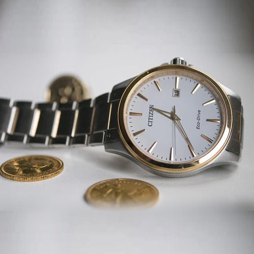 silver-citizen-wrist-watch-beside-coins
