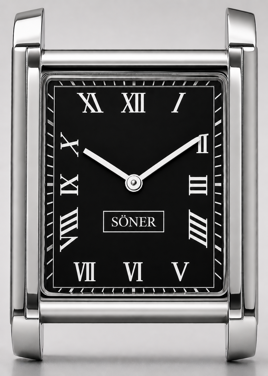 A square silver desk clock with a black face, Roman numerals, and silver hands, displaying the time as 10:09. Inspired by classic Tank Watch aesthetics and featuring refined Swedish design watch details, the brand SÖNER is centered on the clock face.
