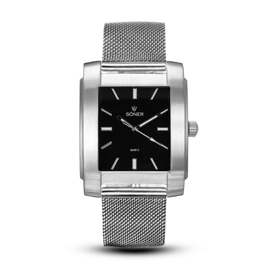 The Legacy Basilica wristwatch from Söner, with its sleek rectangular design, boasts a black face adorned with silver markers and a polished metal casing. Silver hour and minute hands enhance its striking design, complemented by an elegant matching mesh band. The watch face proudly displays "SONER.