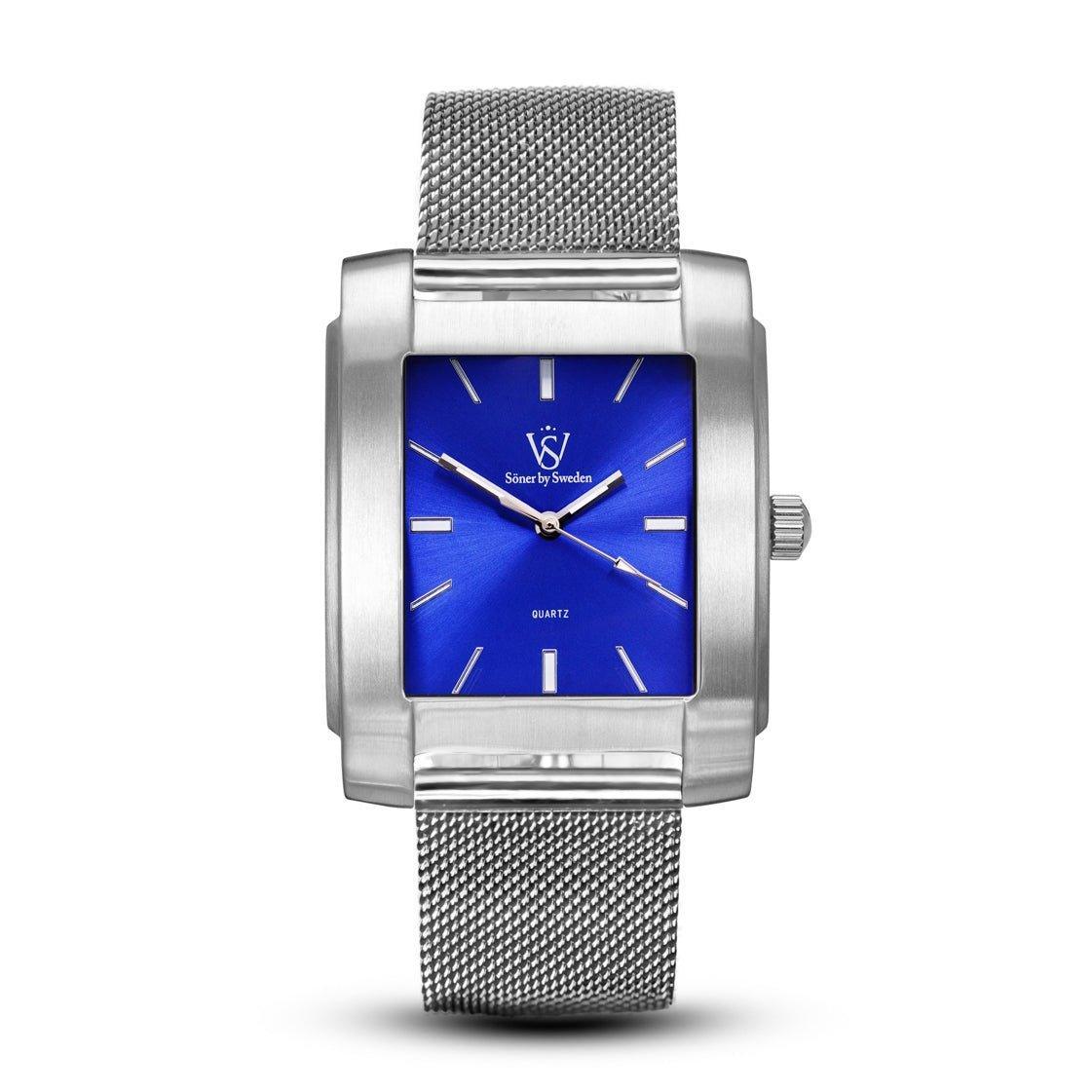 This square wristwatch from Söner, called the Legacy Majorca (3-year Battery), boasts a rectangular design with a textured metal band. It features a vivid blue face complete with silver hour markers and hands, while the brand's logo is prominently positioned near the 12 o'clock mark.