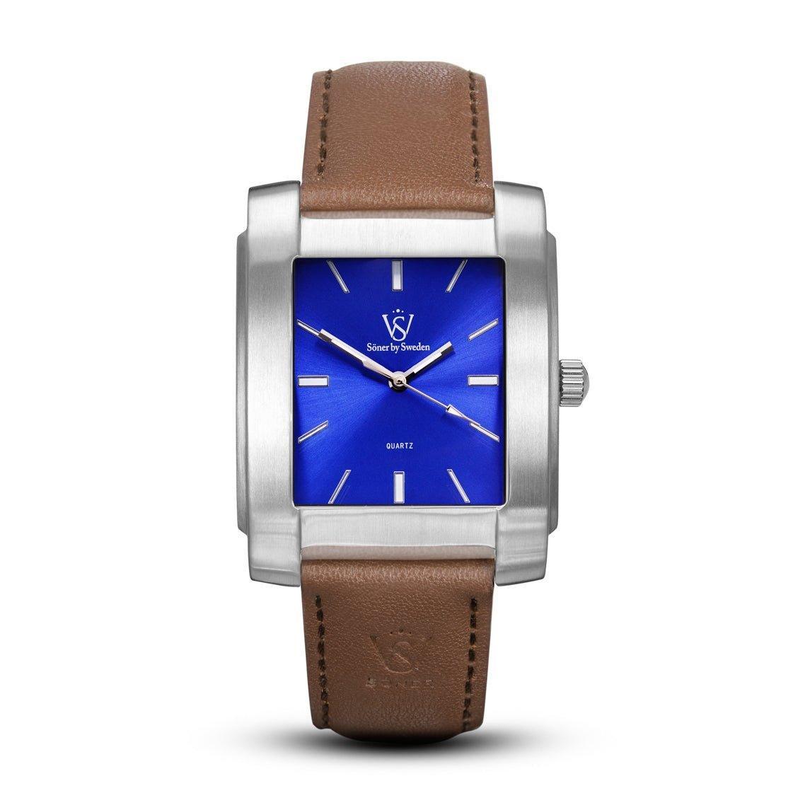 The Legacy Majorca watch from Söner features a blue square face with silver hour markers and hands, complemented by a brown leather strap embossed with "SV" near the clasp. It also boasts a 3-year battery lifespan.