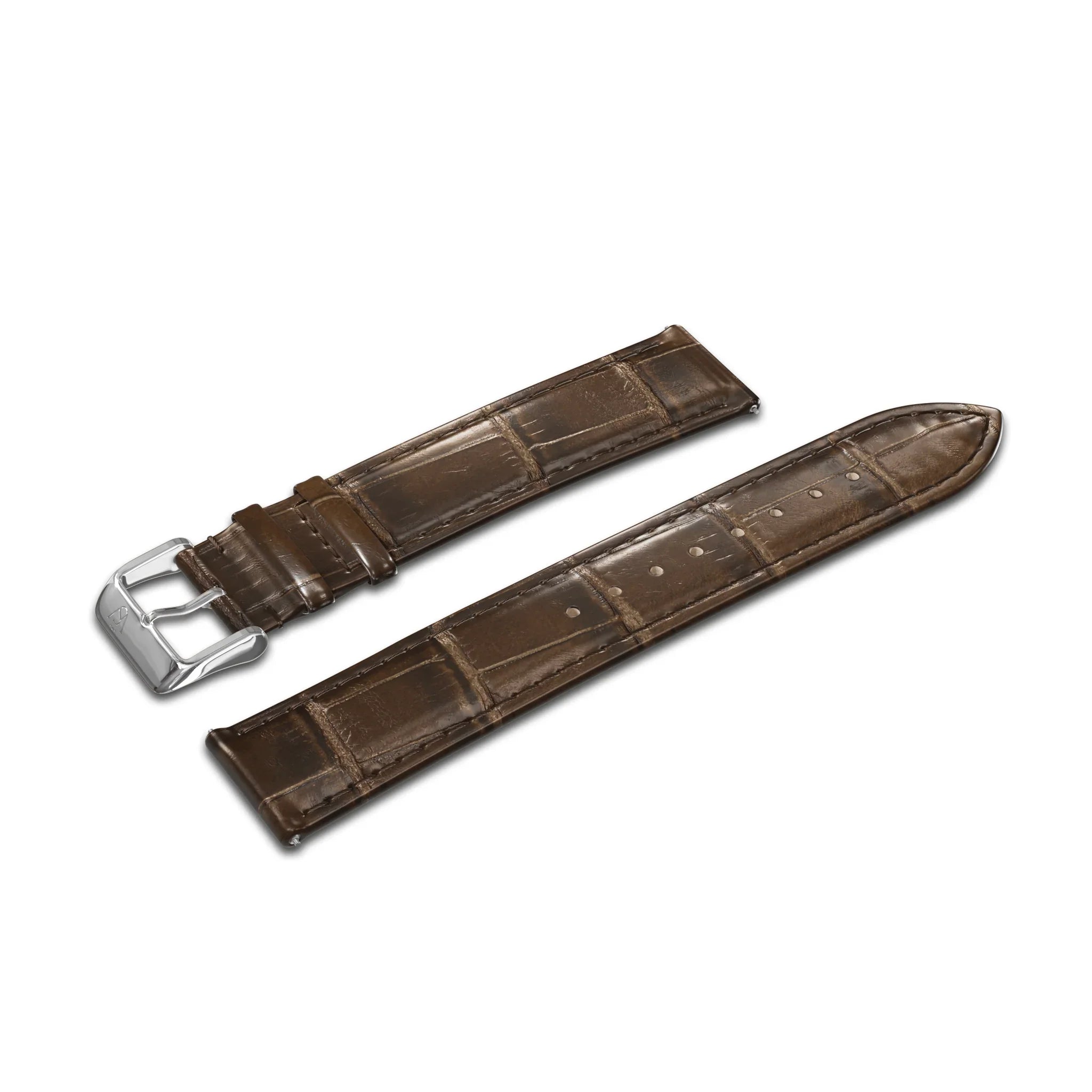 Introducing the GATSBY Mocha Croc (20mm), a brown leather watch strap with an elegant crocodile pattern and a sleek, shiny silver buckle. This strap is designed in two segments: a shorter piece with the buckle and a longer piece equipped with multiple holes for easy size adjustment. The product is presented against a plain white background.