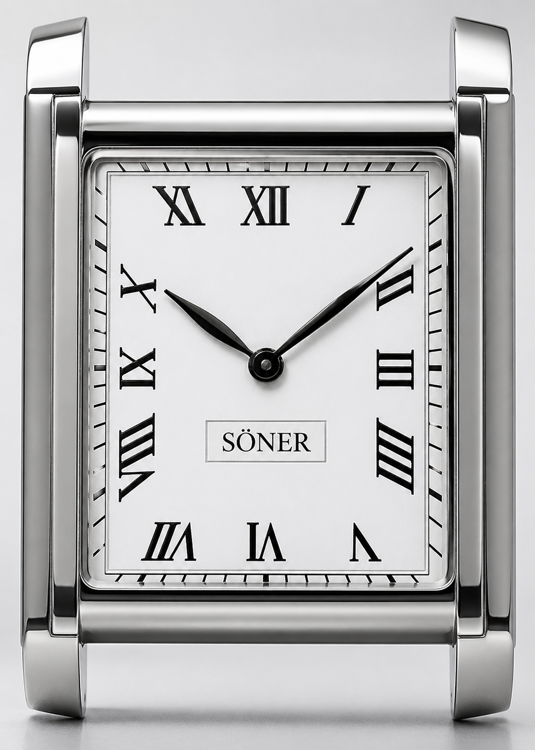 A square, silver desk clock with Roman numerals evokes the elegance of an Art Deco watch. Black hour and minute hands and the word SÖNER grace the white face, showing approximately 10:10.