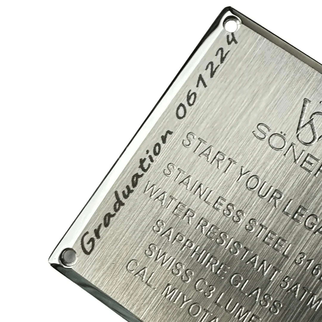 A close-up of a metallic label reads: START YOUR LEGEND, STAINLESS STEEL 316L, WATER RESISTANT 5 ATM, SAPPHIRE GLASS, SWISS C3 LUME, CAL. MIYOTA 9132, with Graduation 061224 engraved diagonally. Product Name: Custom Engraving.