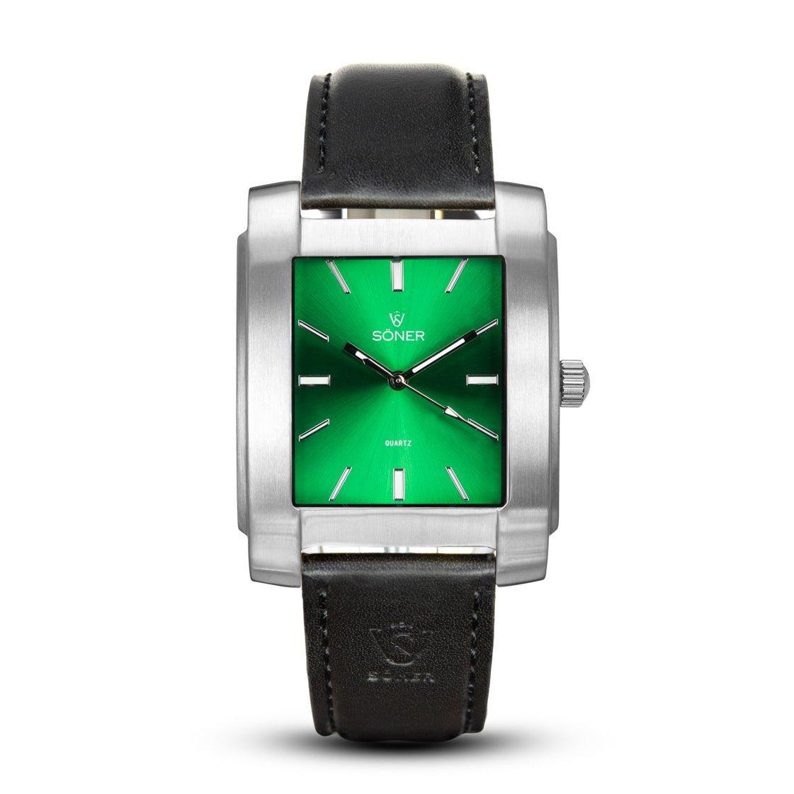 Introducing the Legacy Anstey, a sophisticated rectangular watch featuring a silver case and an eye-catching green dial. The elegant design includes sleek silver hour markers and hands, with the Söner and Quartz labels elegantly displayed on the dial. A black leather strap with visible stitching completes this stylish timepiece. Plus, it boasts a convenient 3-year battery life.