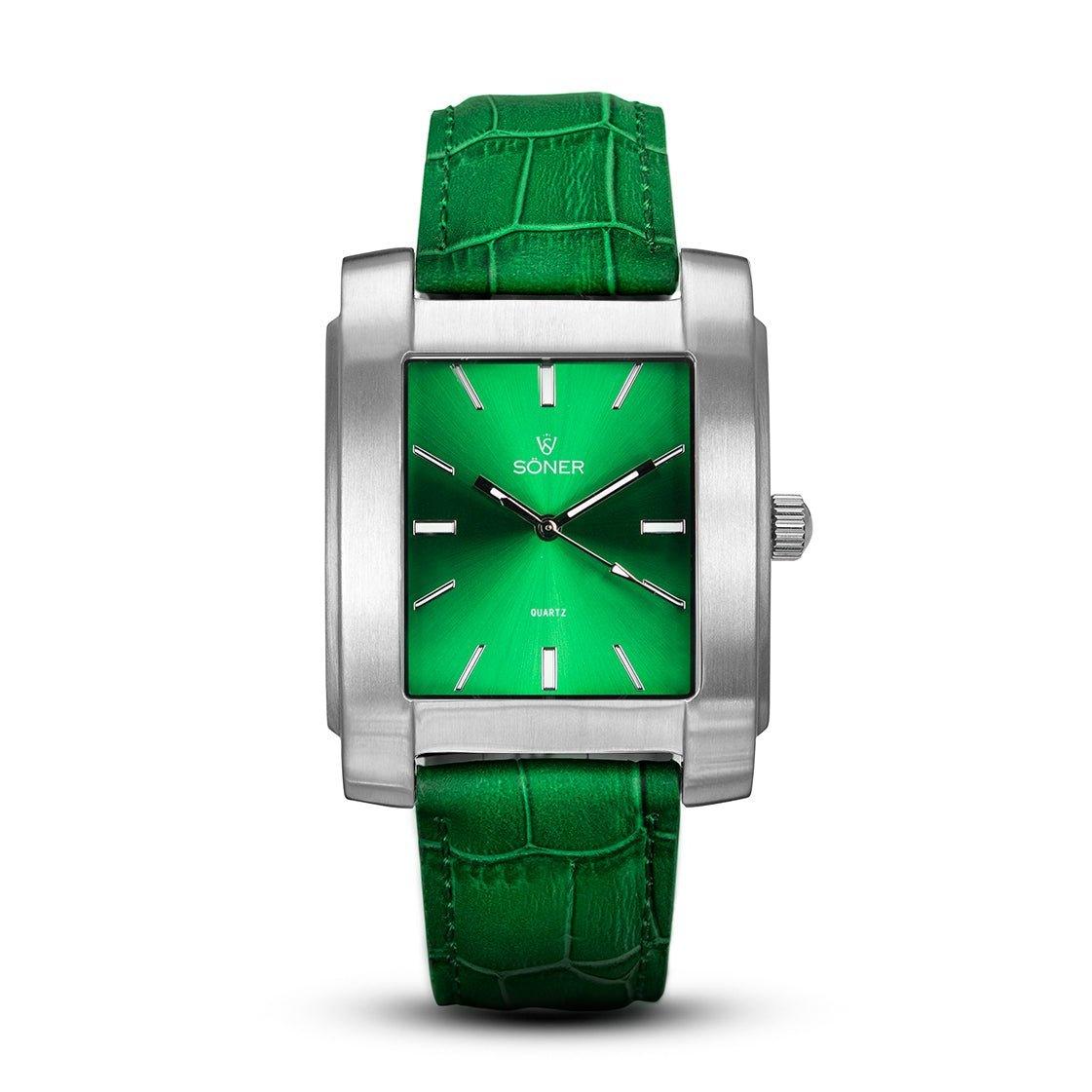 The Legacy Anstey watch by Söner features a sleek silver case, a shiny green face with silver markers, and the elegantly displayed brand name beneath the 12 o'clock marker. Complementing its timeless sophistication is a textured green leather strap adorned with a crocodile pattern.