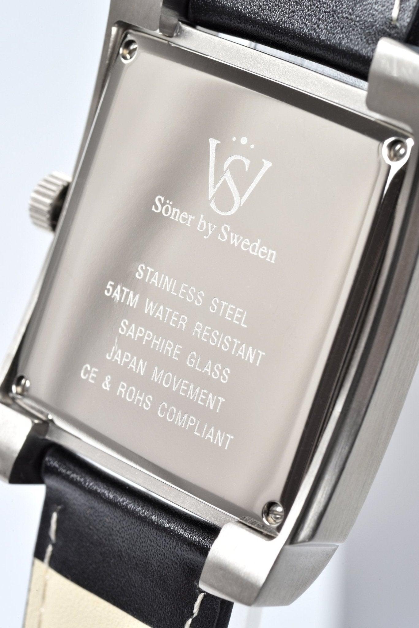 Close-up image of the rectangular watch back from Söner by Sweden, showcasing engraved details: stainless steel construction, 54TM water resistance, sapphire glass, Japan movement, and compliance with CE and ROHS standards. This watch model is the Legacy Anstey (3-year Battery) and is complemented by a sleek black leather strap.