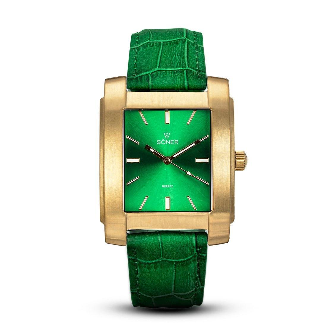 The Legacy Bella, featuring a rectangular design, showcases a green face complemented by a leather strap and gold hour markers and hands. With "Soner" and "Quartz" elegantly marked on its face, the watch includes a prominent gold crown on the right side. This sophisticated timepiece seamlessly blends classic style with modern flair.