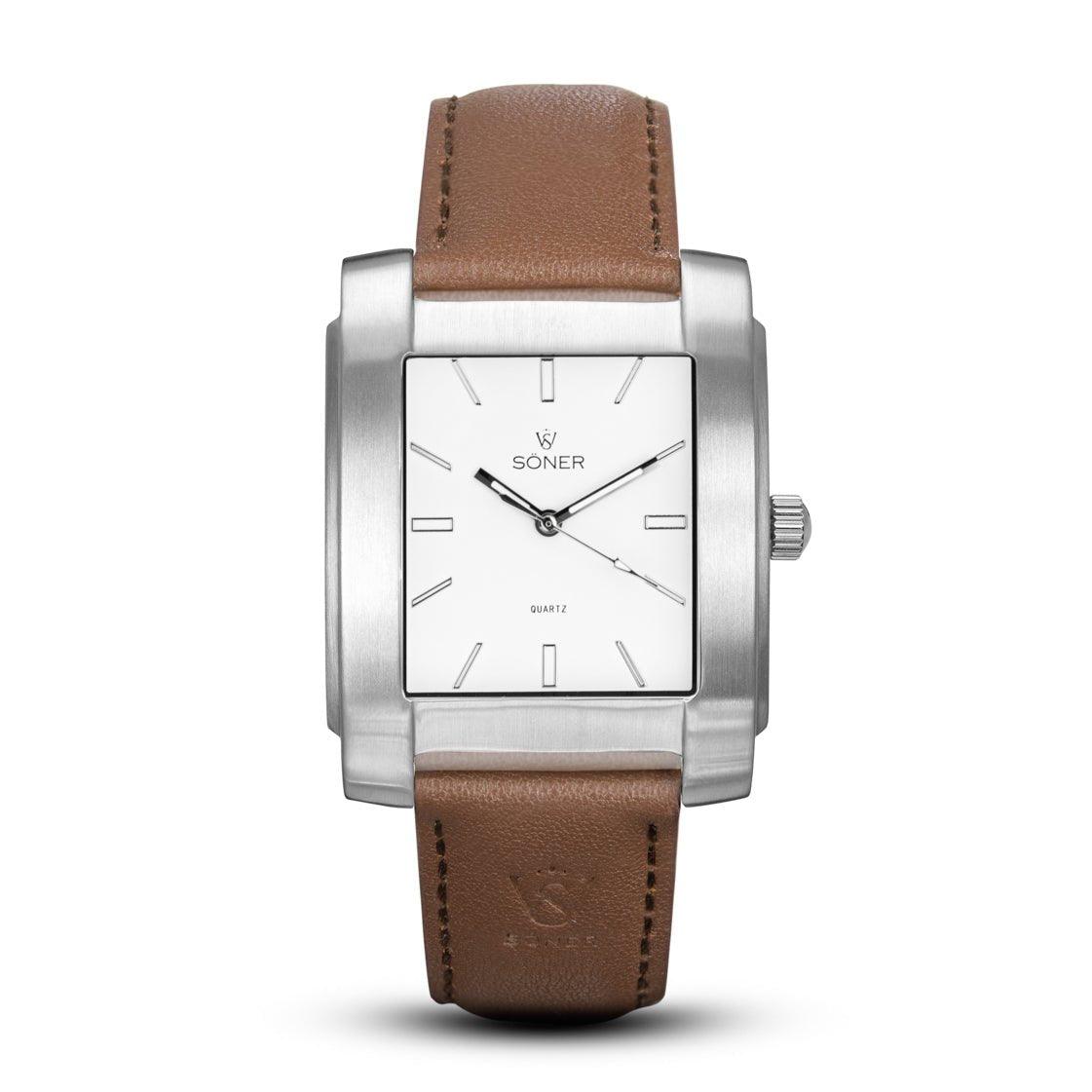 The Legacy Chaillot from Söner watches showcases a rectangular silver case with a white face and minimalist hour markers. The brand name is elegantly displayed, accompanied by a brown leather strap and a prominent crown on the right side. Its hands are precisely set to approximately 10:10, highlighting its meticulous design.