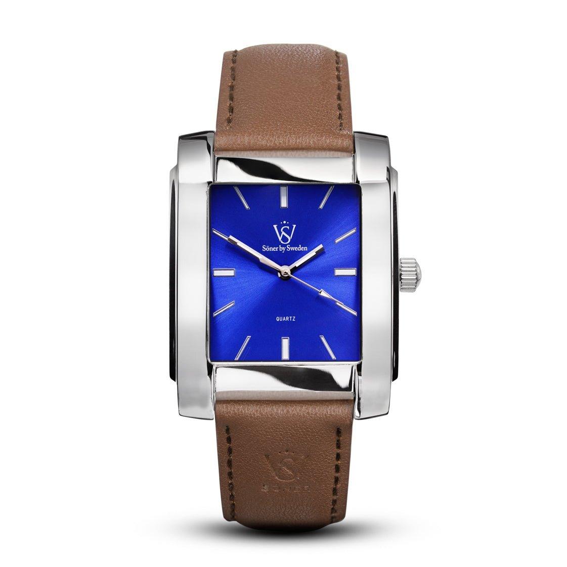 The Legacy Glocke (3-year Battery) is a stylish rectangular wristwatch from Söner featuring a blue face with silver markers and a brown leather strap. It has a silver-toned case with a crown on the right side, while the brand logo and "Quartz" add to its timeless elegance on the dial.