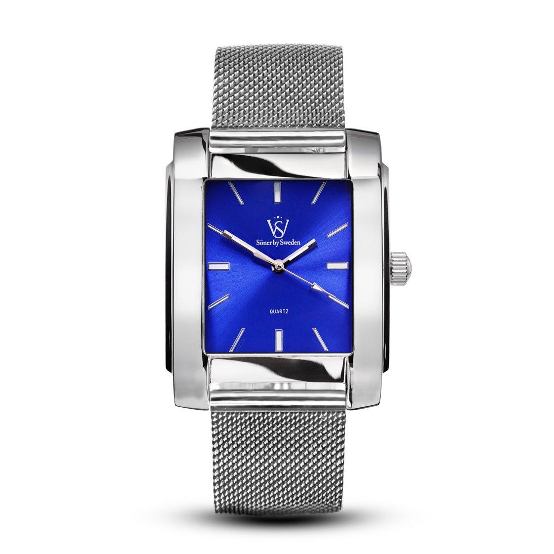 Introducing the Legacy Glocke, a silver wristwatch distinguished by its mesh band and rectangular face. This elegant timepiece showcases a vibrant blue dial, accentuated by sleek silver hour markers and hands, making it a striking accessory for any occasion. Plus, it boasts the reliability of a 3-year battery life.