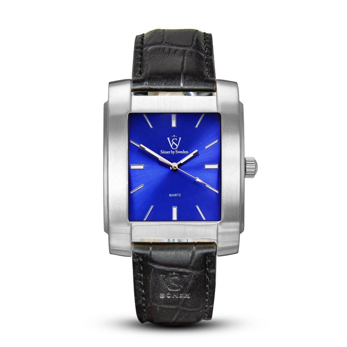 The Legacy Majorca (3-year Battery) men's square watch by Söner showcases a silver case, a blue dial with silver hands and hour markers, and is paired with a black leather strap featuring a textured pattern.