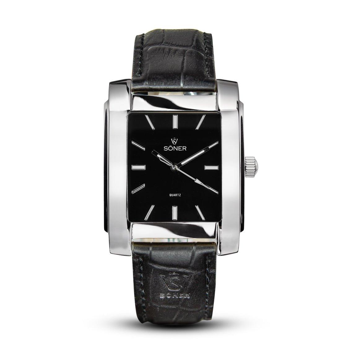 The Legacy Paramount rectangular wristwatch from Söner, with a black face, silver hour markers, and a sleek silver frame, is depicted. This stylish timepiece features an elegant textured pattern on its black leather strap.