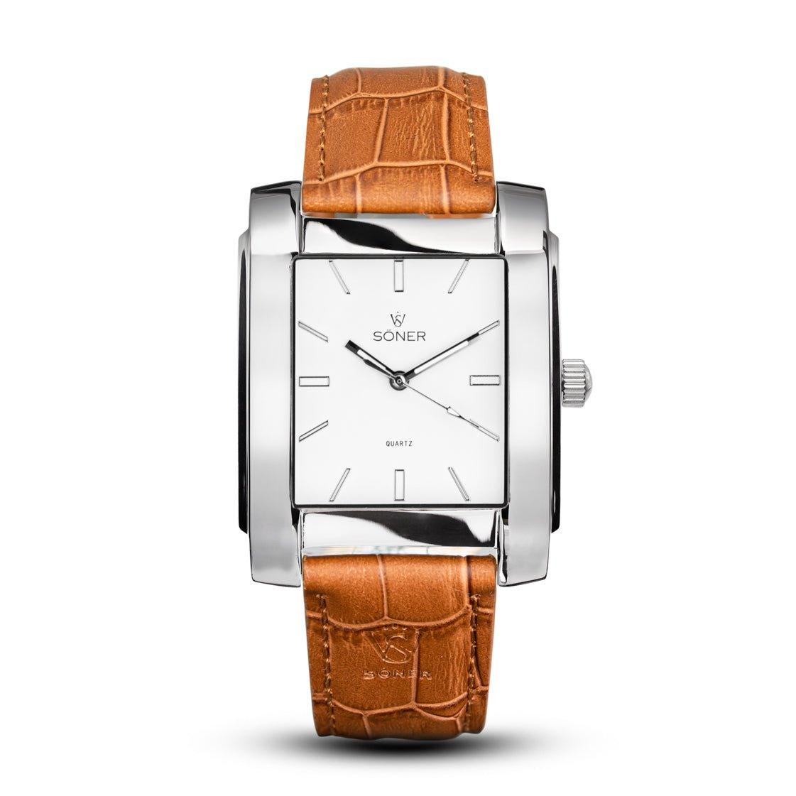 Introducing the Legacy Prisma, a rectangular timepiece featuring a silver case with a white dial and a minimalist design. It showcases pointed silver hands and geometric hour markers, complemented by the Söner brand name and Quartz printed on the dial. This exquisite watch includes a tan leather strap with a textured pattern for added elegance.