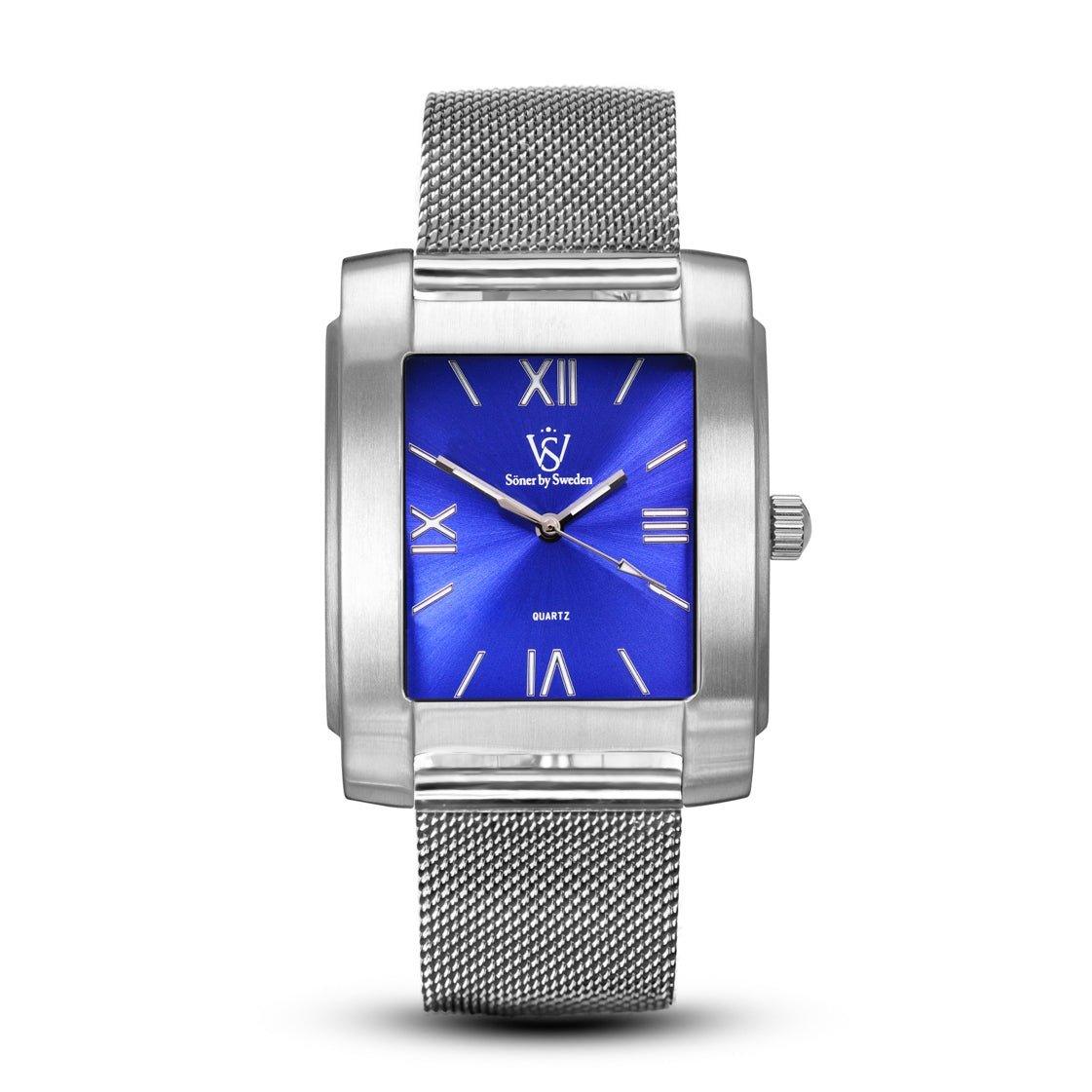 The Legacy Stoclet, characterized by its rectangular shape, features a silver case and a blue dial with Roman numerals. Its stylish mesh band complements the elegant design elements, while the brand logo and name are prominently displayed on the dial. This watch comes with a 3-year battery life.