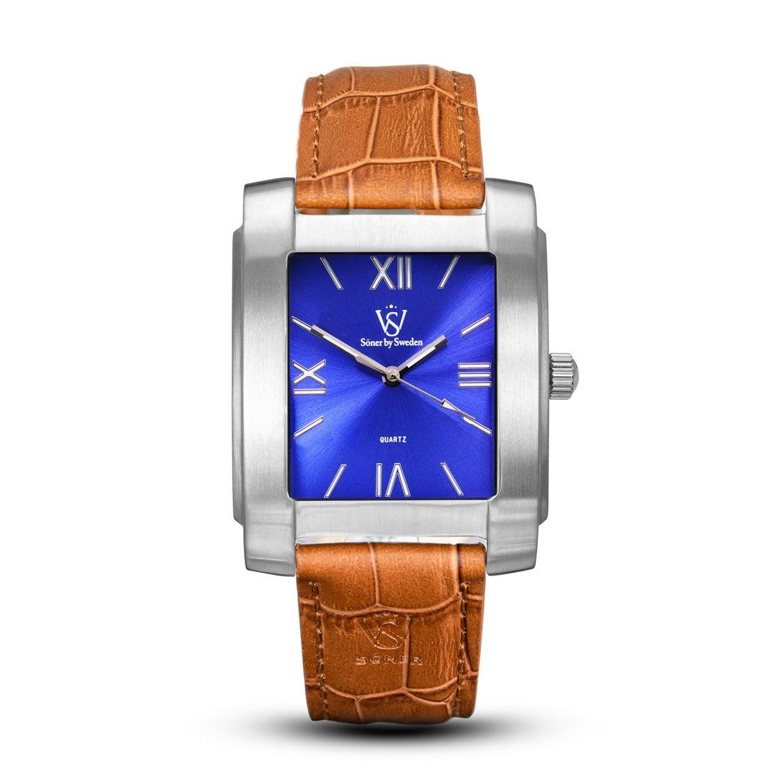 Introducing the Legacy Stoclet (3-year Battery), a rectangular watch characterized by its polished silver case and striking blue dial with Roman numerals. The tan leather strap complements the modern design, evoking the timeless elegance of a square watch from Söner.