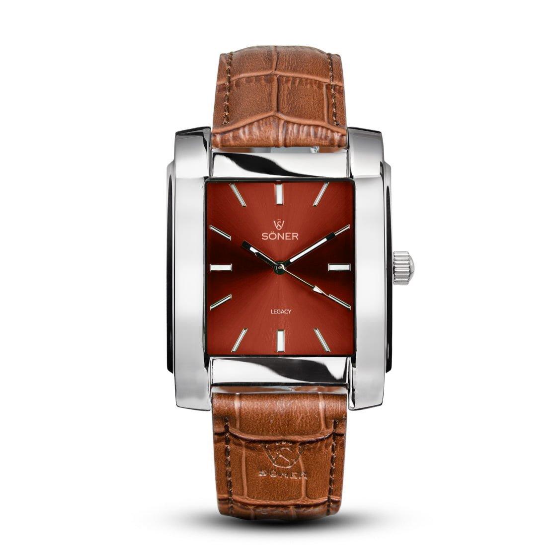 This rectangular watch from Söner, the "Legacy Tribune," features a metallic frame and a brown leather strap. Its rust-colored dial is complemented by sleek silver hour markers and hands. The watch face proudly displays the Soner branding along with the "Legacy Tribune" text, blending classic design with modern elegance. Plus, it boasts a 3-year battery life for lasting performance.