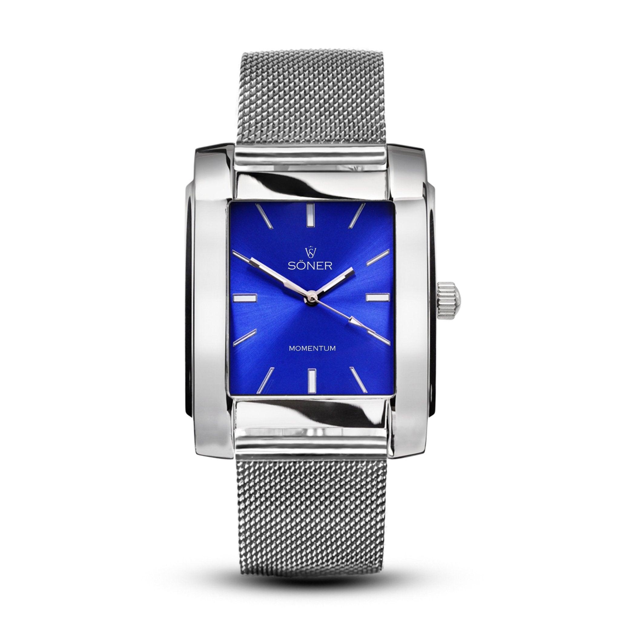 The Momentum Bacardi (Self-winding) features a sleek rectangular design with a silver case, a blue dial, and minimalist silver hour markers. It comes with a mesh stainless steel strap and has a crown on the right side. The Soner brand name is prominently displayed on the dial.