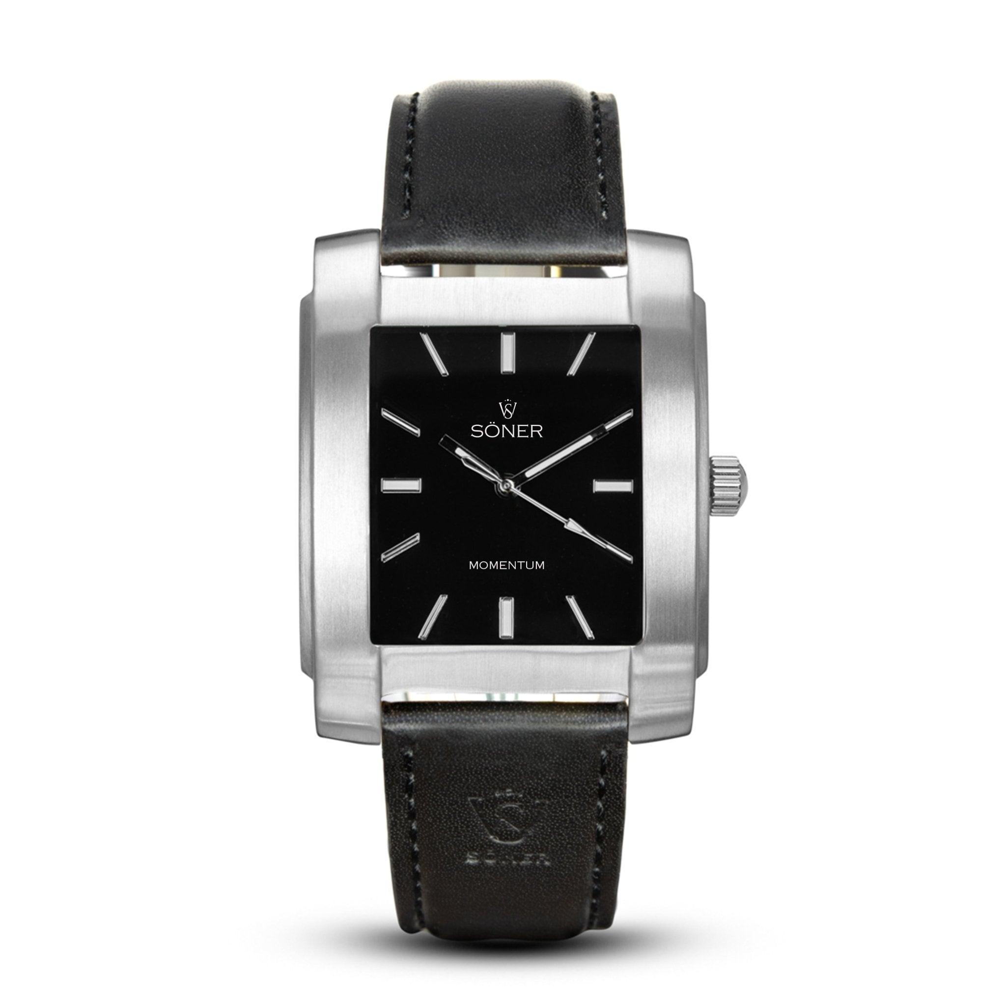 The Momentum Eden (Self-winding) watch features a sleek rectangular design with a black leather strap and a silver frame. Its elegant black dial displays minimalist white hour markers and hands, with the brand names Söner and MOMENTUM printed on it, all set against a pristine white background.