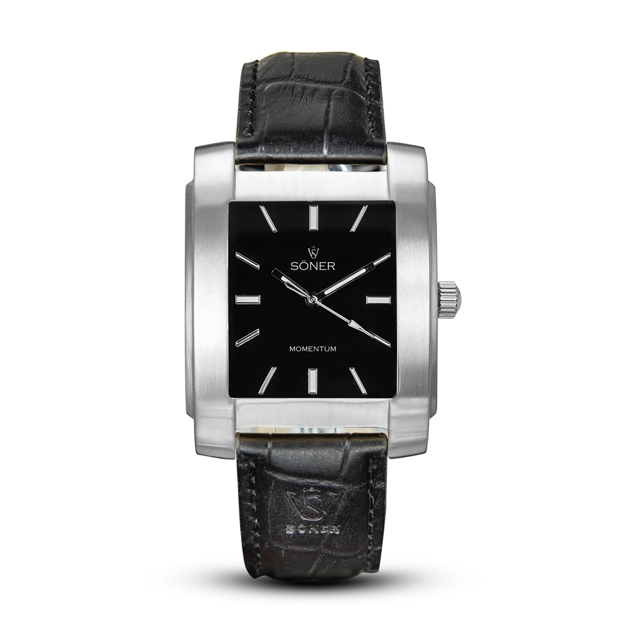 Introducing the Momentum Eden, a rectangular watch with a black leather strap and a sleek silver metallic case. The elegant black dial features silver hour markers and hands, with the names SONER and MOMENTUM gracefully displayed on its face.