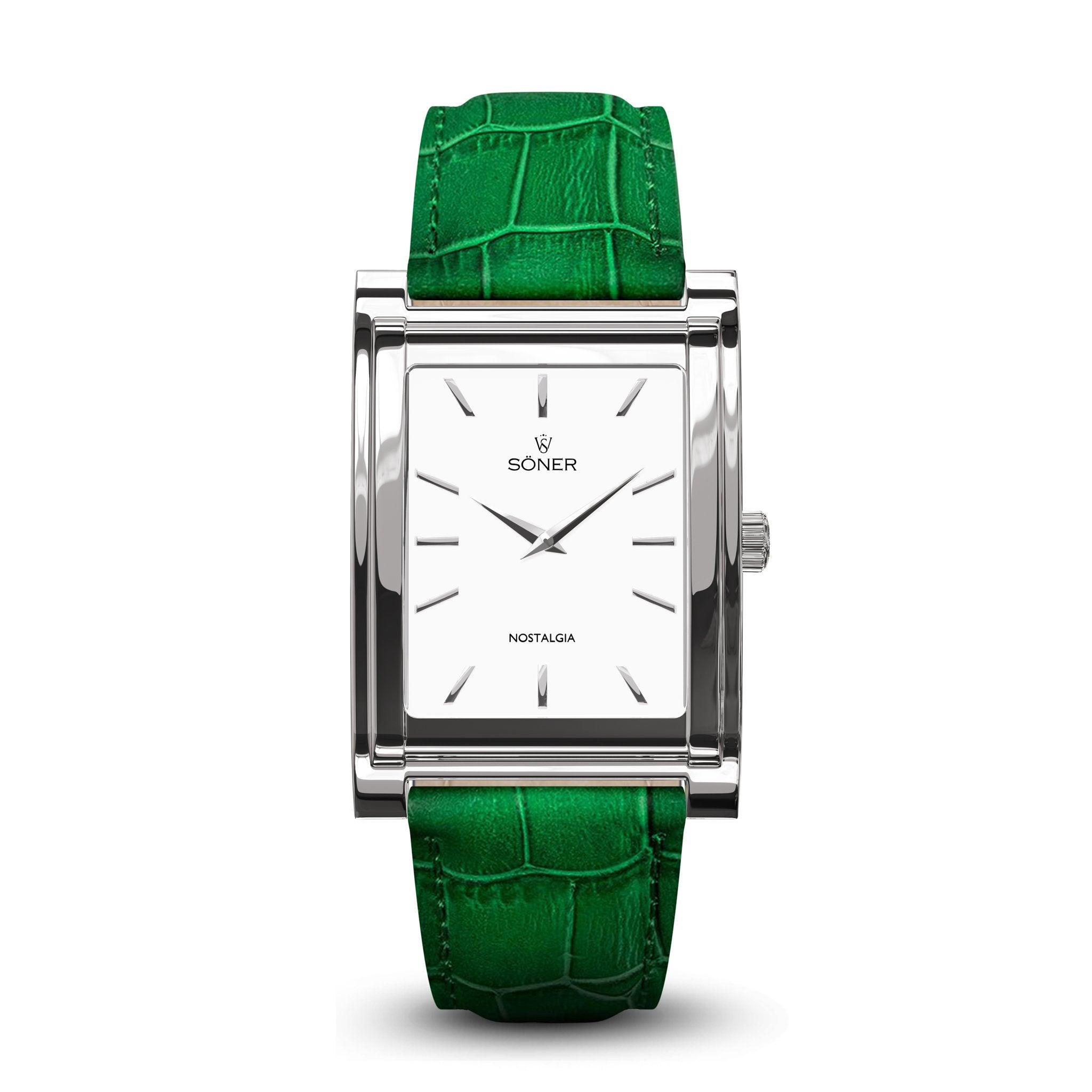 The Nostalgia Paris watch by Söner boasts a rectangular silver-tone case, a white dial, and minimalist hour markers. "SONER" and the word "Nostalgia" are elegantly printed on the dial. A vibrant green alligator-patterned leather strap finishes off this stylish timepiece, which comes equipped with an impressive 11-year battery.