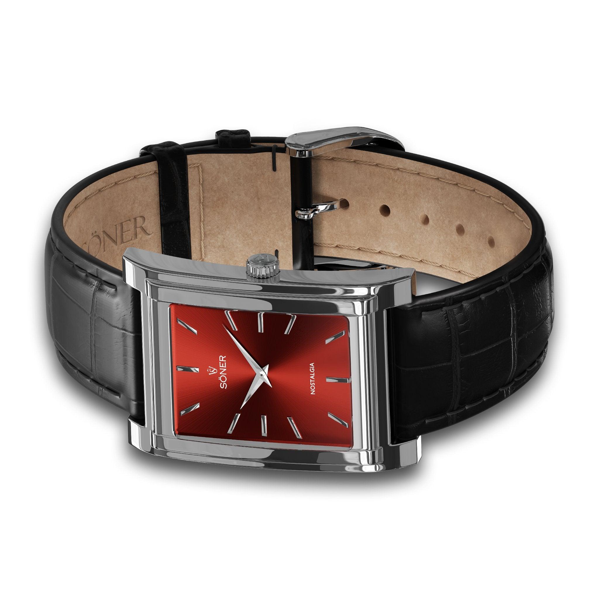 Introducing the Nostalgia Rome (11-year Battery), a luxurious men's watch with a rectangular design that showcases an eye-catching red metallic face and sleek silver hour markers. Paired perfectly with a textured black leather strap and secured by a polished silver buckle clasp, this elegant timepiece exemplifies the exquisite craftsmanship associated with Söner's distinguished collection.